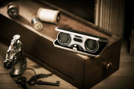 Closeup vintage folding opera glasses. Old compact binoculars.の写真素材