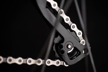 Closeup the chain on the moutain bike over black background.