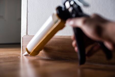 The man applying silicone caulk. The man fixing home.の写真素材