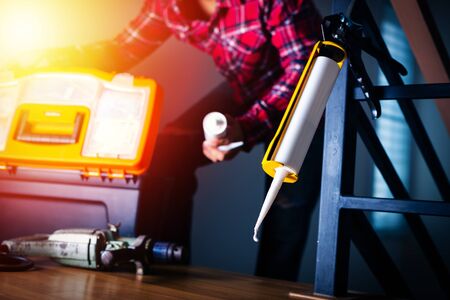 The man applying silicone caulk. The man fixing home.の写真素材