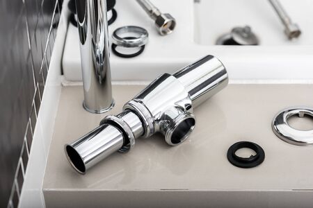 new metal siphon and other sink equipments in the bathroom.の写真素材