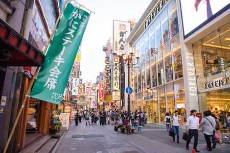 OSAKA, JAPAN - MAY 20, 2016: Many tourists walking in Dotonbori, the famous shopping street in Osaka, Japan.のeditorial素材