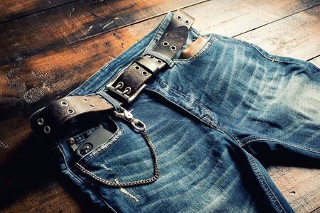 Blue jeans with rock style of brown genuine leather belt and other men accessories.