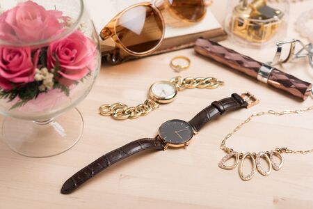 Woman wristwatch with black dial and brown leather bracelet.