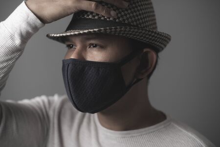 Portrait of asian man wearing cloth mask to against air pollutionの写真素材