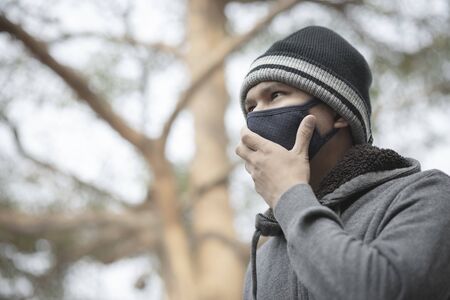 Portrait of asian man wearing cloth mask to against air pollutionの写真素材