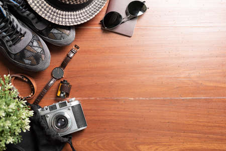 Clothing and accessories for travel on wood background. Travel preparation concept. の写真素材