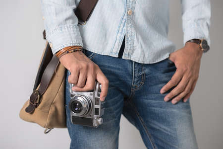 Old film camera in man's hand. Photography and hobby concept. の写真素材