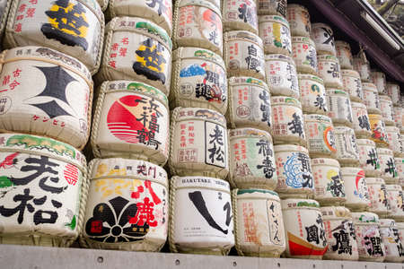 TOKYO, JAPAN - FEBRUARY 19, 2019: Barrels of Sake (Nihonshu) wrapped in staw at Meiji Jingu Shrine located in Shibuya, Tokyo, Japan. The shrine is one of the most famous landmarks in Tokyo.のeditorial素材