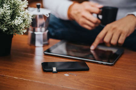 SIM card for smart phone. The man changing the SIM card.
