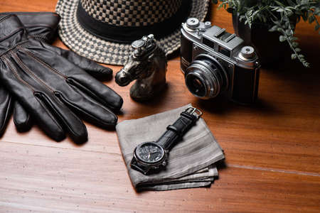 Closeup at luxury men wristwatch with black dial and leather strap.
