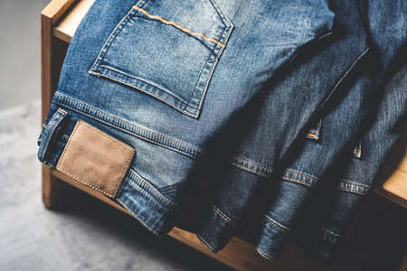many blue jeans on concrete background. men fashion denim jeans.の写真素材