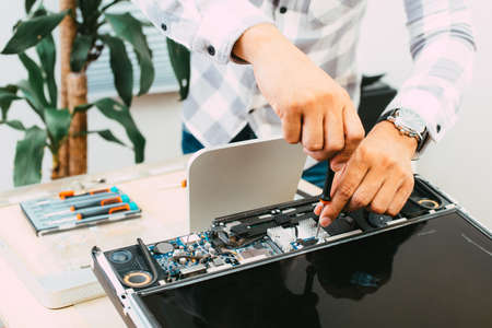 Technician reparing a broken computer. Computer service and repair concept.の写真素材