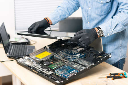 Technician reparing a broken computer. Computer service and repair concept.の写真素材