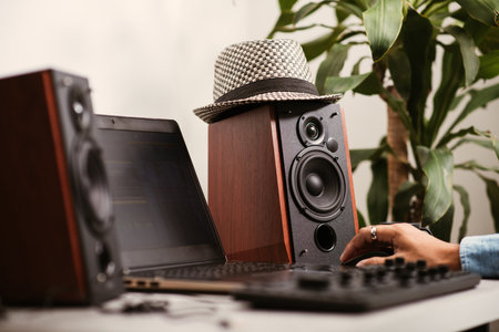 Workstation with speakers and computer in studio. Desktop in home office. Selective focus on the speaker.の写真素材