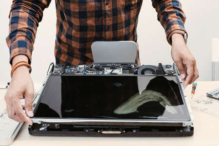 Technician reparing a broken computer. Computer service and repair concept.の写真素材