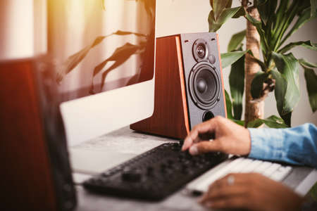 Workstation with speakers and computer in studio. Desktop in home office. Selective focus on the speaker.の写真素材