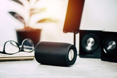 Black wireless portable  speaker for music listening. Voice assistant speaker at home.の写真素材
