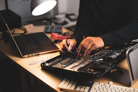 Technician reparing a broken computer. Computer service and repair concept.の写真素材