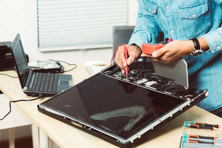 Technician reparing a broken computer. Computer service and repair concept.の写真素材