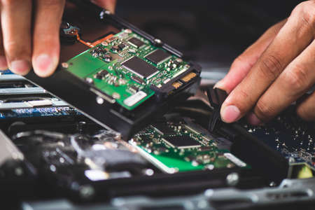 Technician reparing a broken computer. Computer service and repair concept.の写真素材