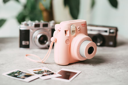 BANGKOK, THAILAND - OCTOBER 11, 2019: The pink Fujifilm Instax mini 8, instant camera with Instax Mini format (54 mm x 86 mm).のeditorial素材