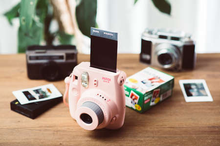 BANGKOK, THAILAND - OCTOBER 11, 2019: The pink Fujifilm Instax mini 8, instant camera with Instax...