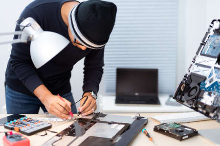 Technician reparing a broken computer. Computer service and repair concept.の写真素材