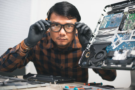 Technician reparing a broken computer. Computer service and repair concept.