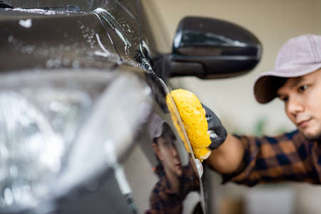 Washing the black car. Car cleaning and car care concept.の写真素材