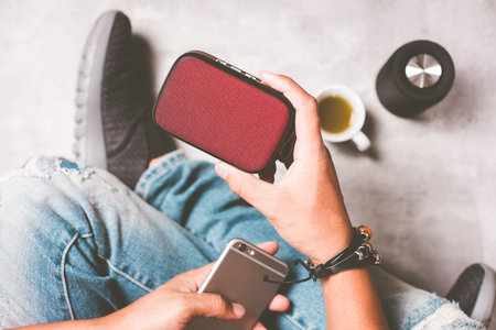 relaxing concept, the man using wireless portable speaker for music listening.の写真素材