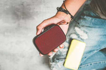 relaxing concept, the man using wireless portable speaker for music listening.