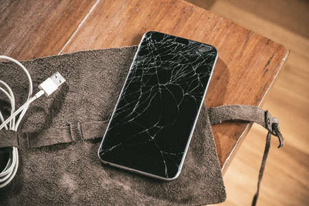 closeup cracked screen on broken smart phone.