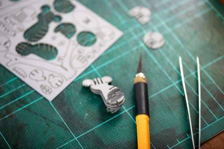 Assembling small cardboard model, the small cardboard parts are made with laser cutting technology. Hobby for adult concept.の写真素材