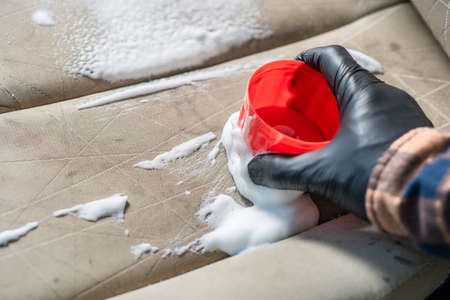Cleaning the car seat with foam chemical, car care conceptの写真素材
