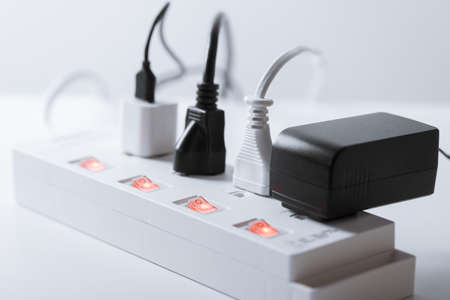 Many plugs connected to the power strip with individual switches.