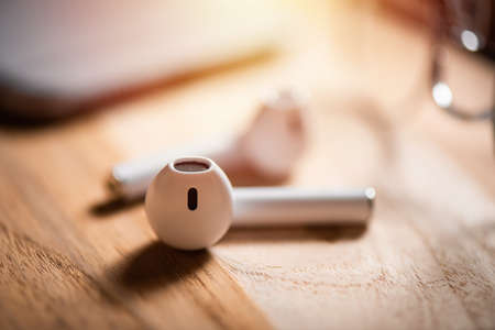 Pair of white wireless earbuds for smartphone. Relaxation concept.の写真素材