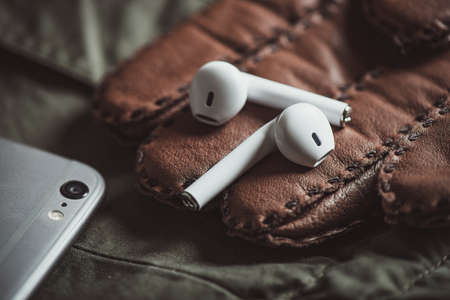 Pair of white wireless earbuds for smartphone. Relaxation concept.の写真素材