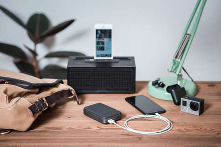 Smartphone battery charging with power bank. close-up at the grey power bank.の写真素材