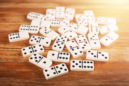 Domino tiles on wooden table. Dominoes is one of the most famous classic game.