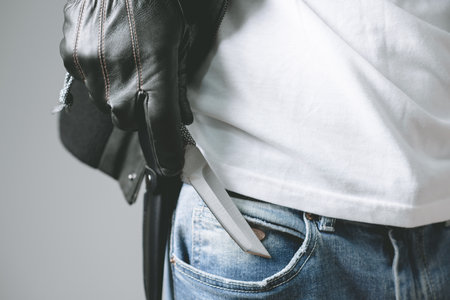 The man holding a pocketknife with Tanto blade in hand.の写真素材