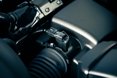 Car mass air flow sensor in the engine room. Car maintenance concept.
