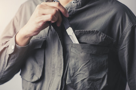 The man holding a pocketknife with Tanto blade in hand.の写真素材