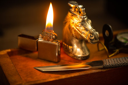 Close up stainless steel pocketknife with Tanto blade and the lighter. Sterilize the knife concept.の写真素材