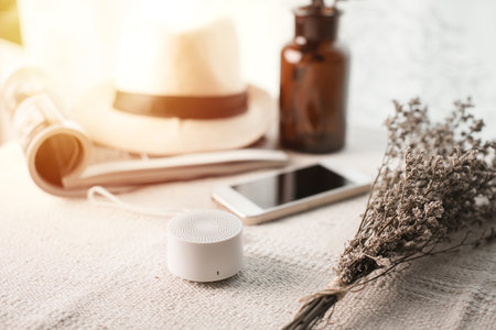 Relaxing concept, Close up portable speaker for music listening on the desk with dried flowers.