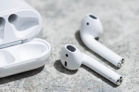 Pair of white wireless earbuds for smartphone. Relaxation concept.の写真素材