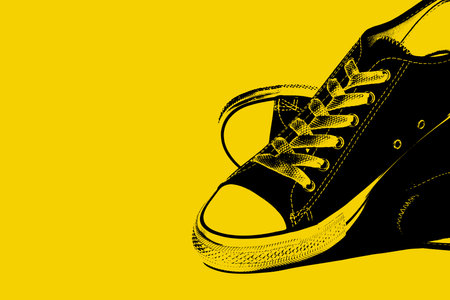 Canvas sneakers isolated over yellow background.の写真素材