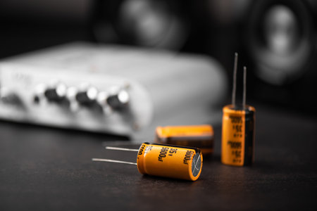 Technician repairing the electronic device. Reparing the audio amplifier. Close up at the orange capacitor.の写真素材