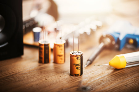 Technician repairing the electronic device. Reparing the audio amplifier. Close up at the orange capacitor.の写真素材