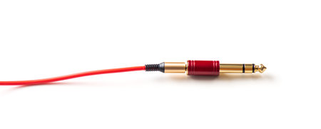 Red AUX(Auxiliary) cable with Male jack isolated over white background. Cable for stereo input and output.の写真素材